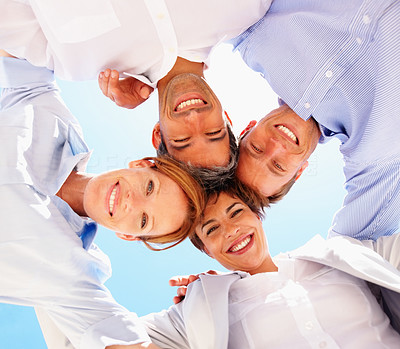 Upward view of business colleagues with heads together