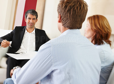 Successful bank executive in a discussion with a young couple
