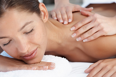 Happy woman getting a back massage at the spa