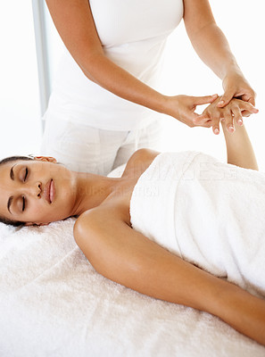 Pampered woman treating herself with a massage by a professional masseuse