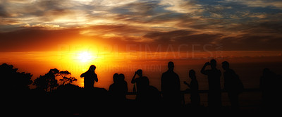 Men, women, and children watching the sunset