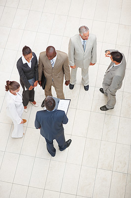 Upward view of a team of business colleagues standing together