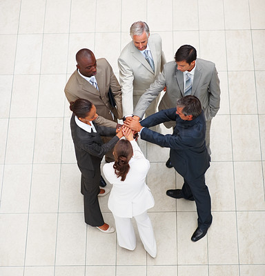 Upward view of business colleagues with their hands together in unity