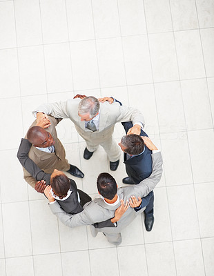 Upward view of a team of business colleagues together in a circle