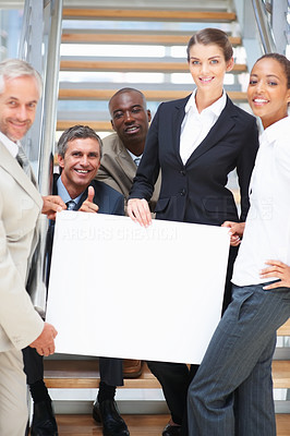 Business people holding a blank board on the stairs