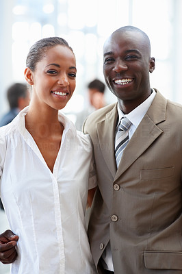 Two African American business people posing together and smiling