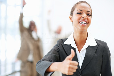 A fresh African American business woman showing a thumbs up sign