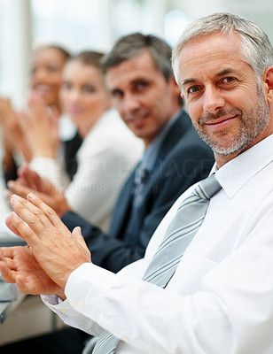 A successful business team applauding at a conference