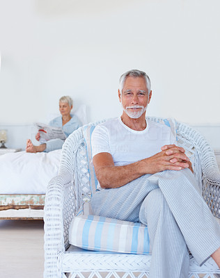 A senior old retired man sitting at home