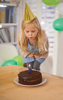 Blowing out her birthday candle