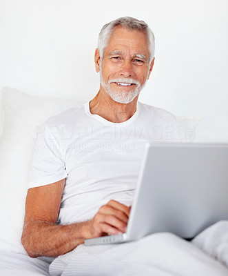 A senior retired happy man with a laptop