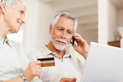 Senior couple shopping from the net with their credit card