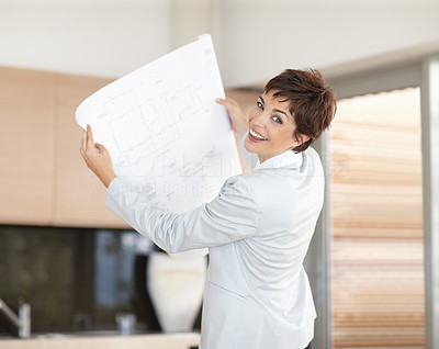 Successful interior designer holding a planning chart