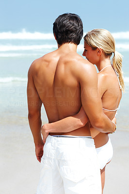 Sweet nice woman hugging her boyfriend on the sea shore