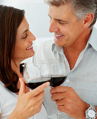 Closeup of a charming mature couple drinking a glass of wine together