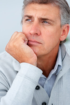 Closeup of a mature business man looking away and thinking