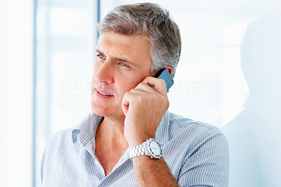 Closeup of a handsome mature man speaking on a cellphone