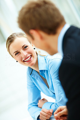 Happy business woman in a conversation with her colleague