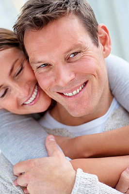 Closeup portrait of a smiling young female hugging her husband from behind