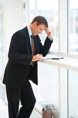 Successful young business man going through a file