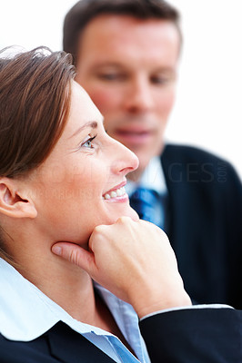Closeup of smiling business female looking away with colleague at the back