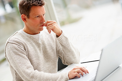 Portrait of busy man working on laptop