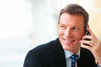 Portrait of handsome business man speaking on mobile phone
