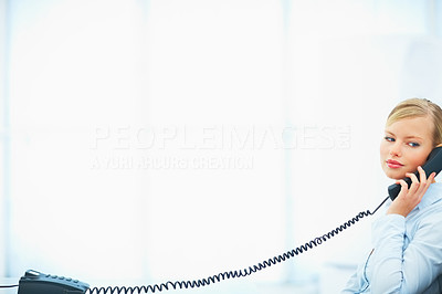 Young female speaking on the telephone on white background