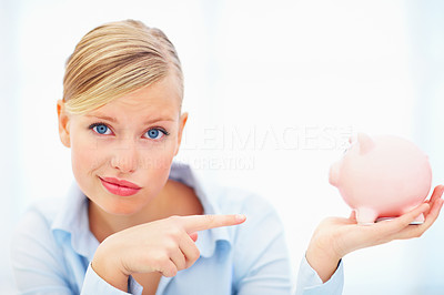 Closeup of woman giving weird smile holding piggybank