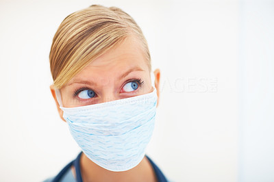 Portrait of young lady surgeon with face mask over white background