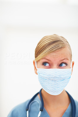 Closeup portrait of young lady surgeon with face mask