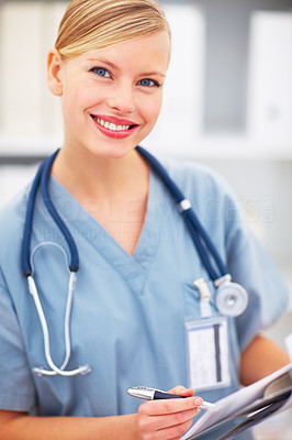 Portrait of beautiful lady doctor with pen and notepad