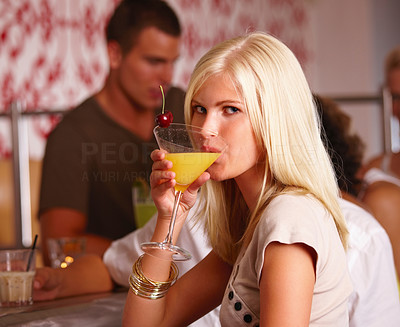 Portrait of beautiful young girl drinking cocktail