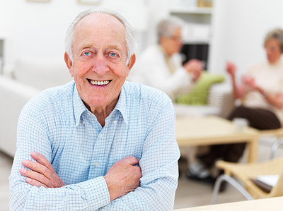 Smiling older man with people in background