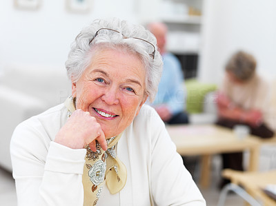Smiling old woman with people in the background