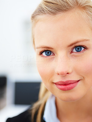 Smiling young business woman with blue eyes