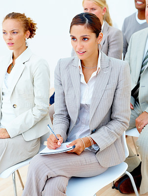 Business woman taking notes in meeting