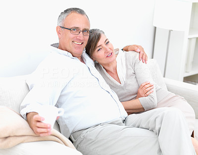 Romantic old couple sitting together on couch