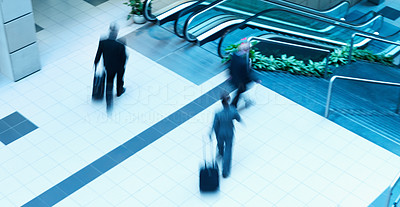 Motion blur of busy business people walking in mall