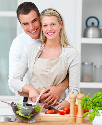 Happy couple preparing food in the kitchen