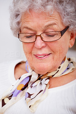 Closeup of an old woman smiling and looking down