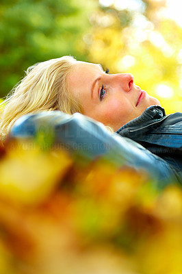 Closeup of a woman lying on leaves smiling