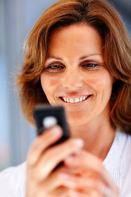 Pretty young female text messaging on mobile