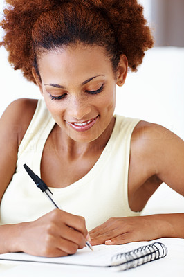 Woman writing down notes in book