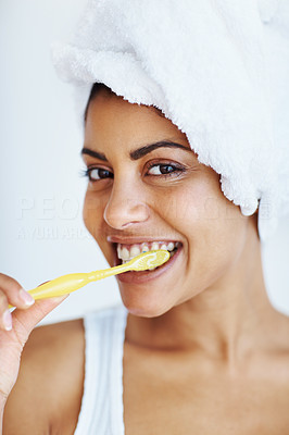 Smiling woman brushing teeth
