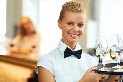 Happy waitress with tray of glasses