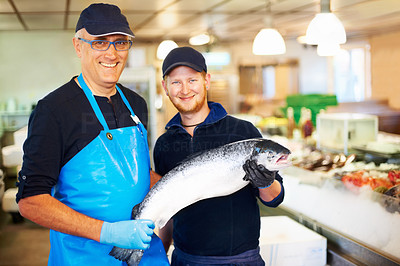 Fishmongers holding a fish