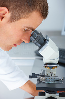 Closeup of a scientist looking through telescope at laboratory