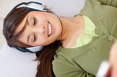 Top view of a cute female hearing music on mp3