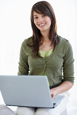Lovely young lady using a laptop , browsing the internet